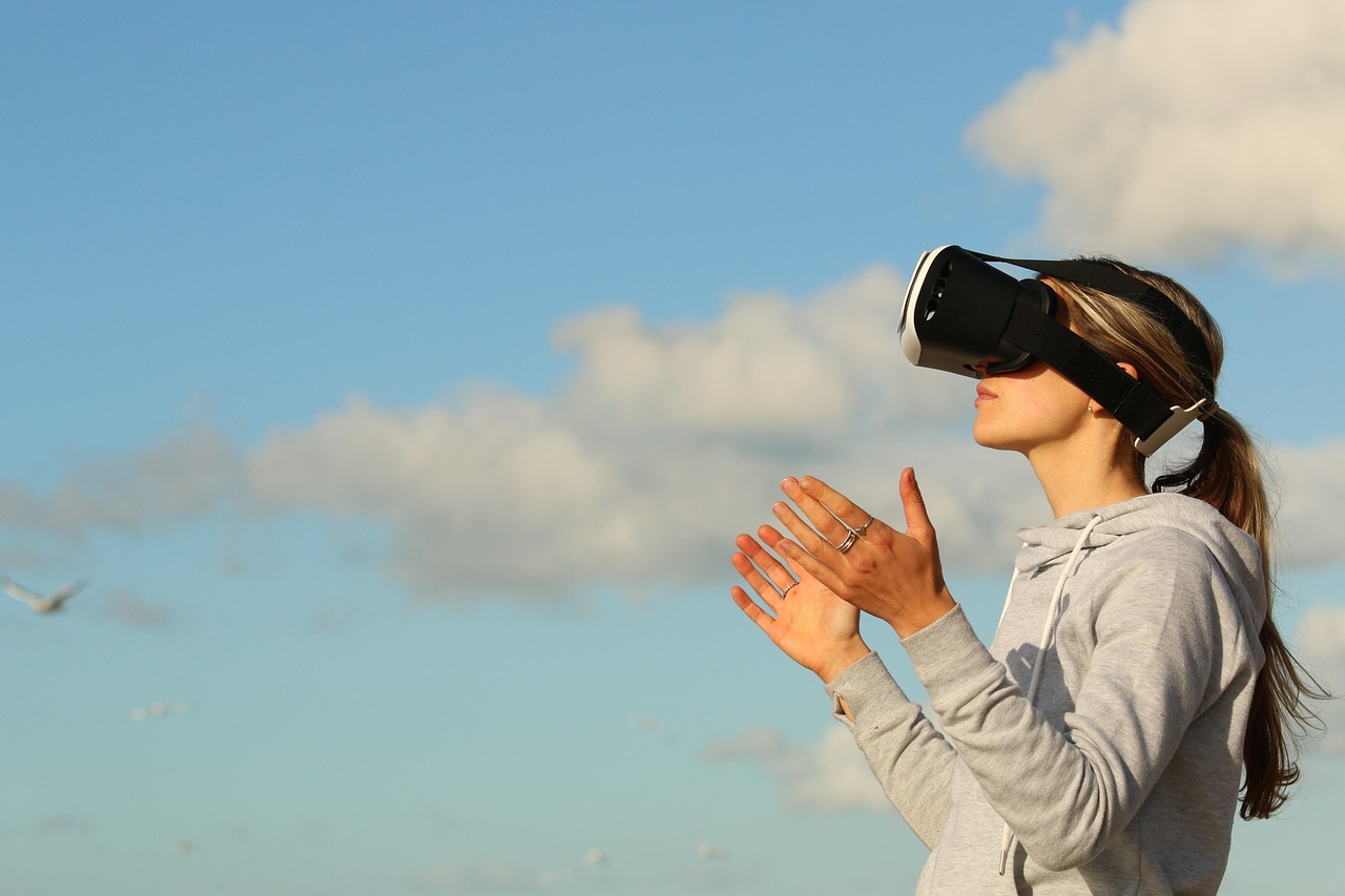 A woman wearing a virtual reality headset, lit from behind by cool blue light