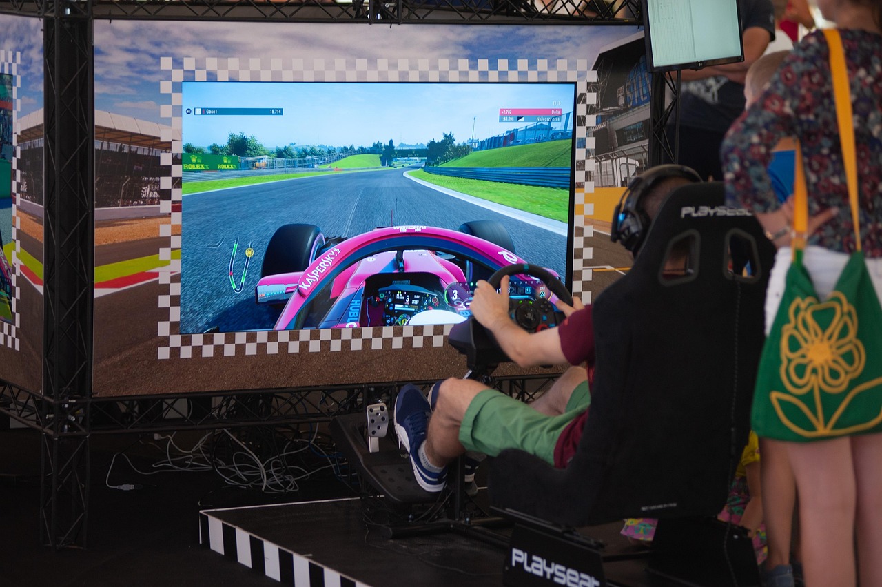 A racing simulator rig with a steering wheel, pedals and a wraparound screen