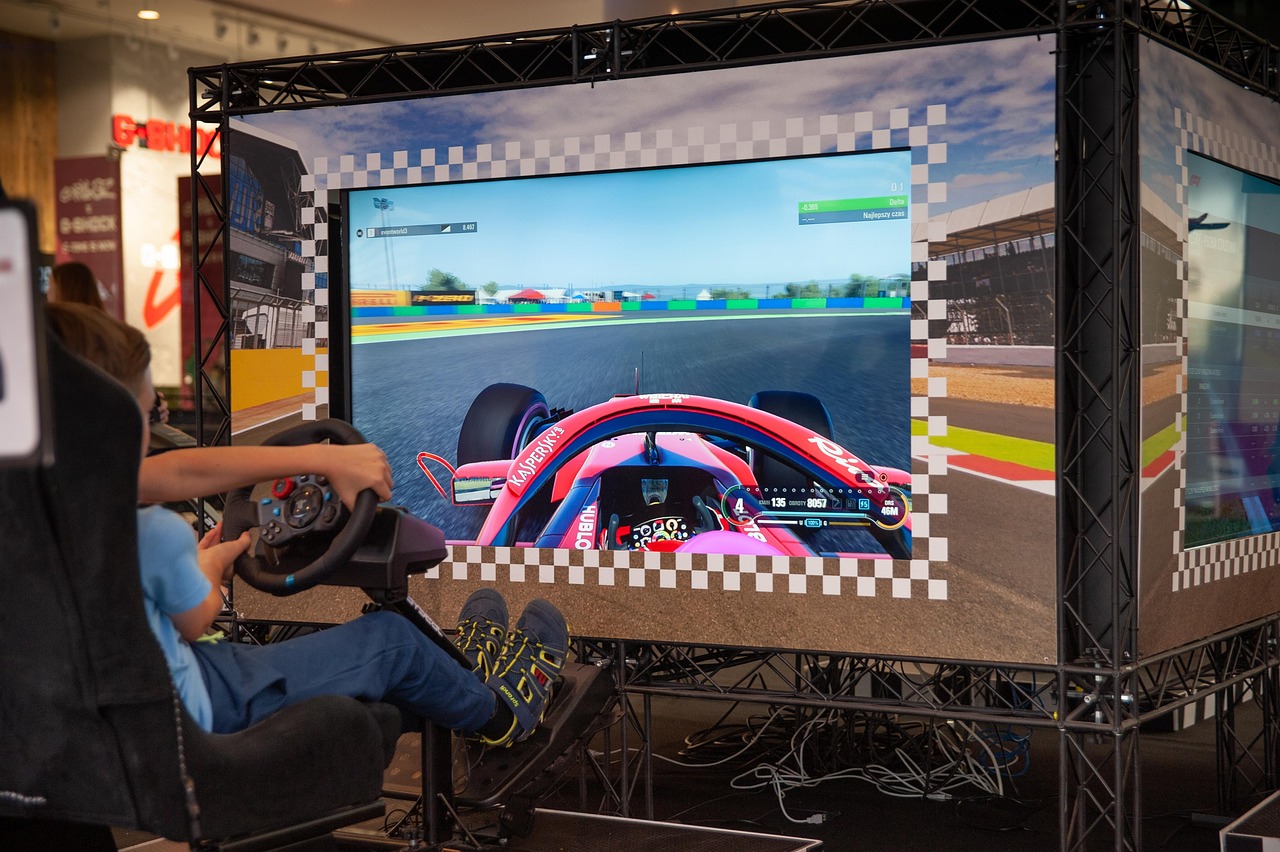 A second racing simulator rig lit from the side in a dark space.