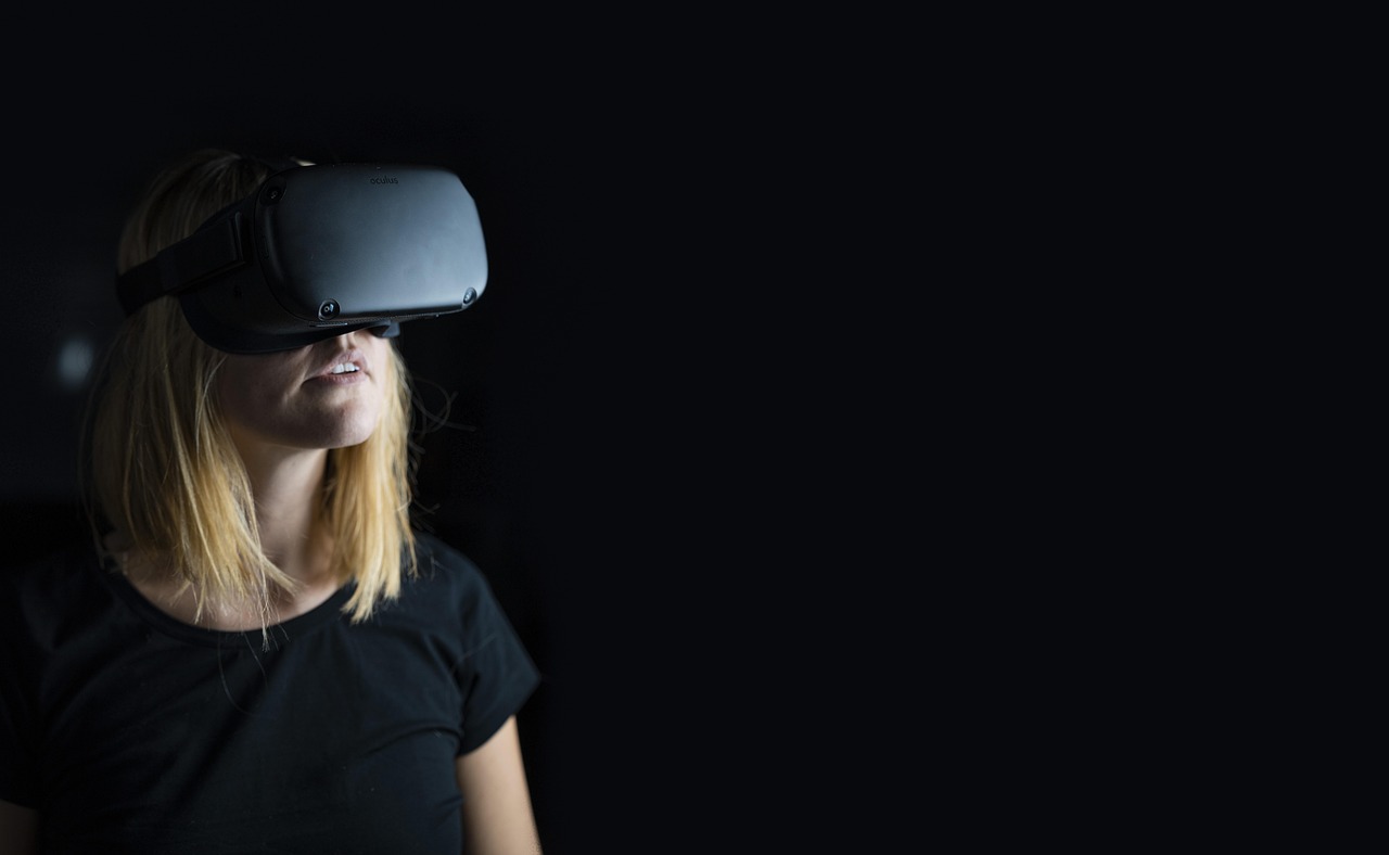 A headset glowing in a dark room, lenses lit from within.