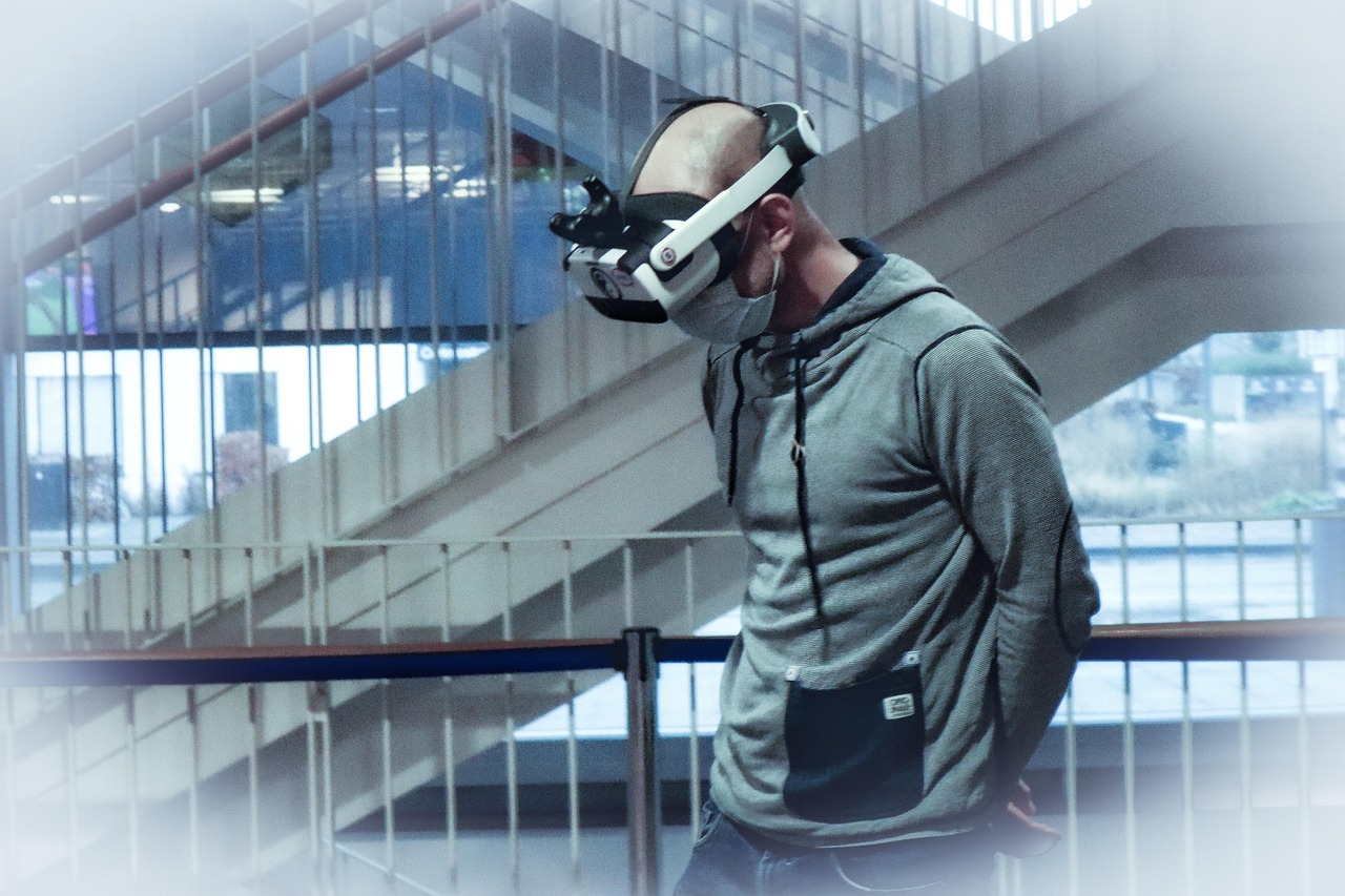 A man in a VR headset reaching out toward something only he can see